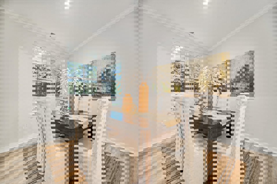 A dining room with a table and chairs.