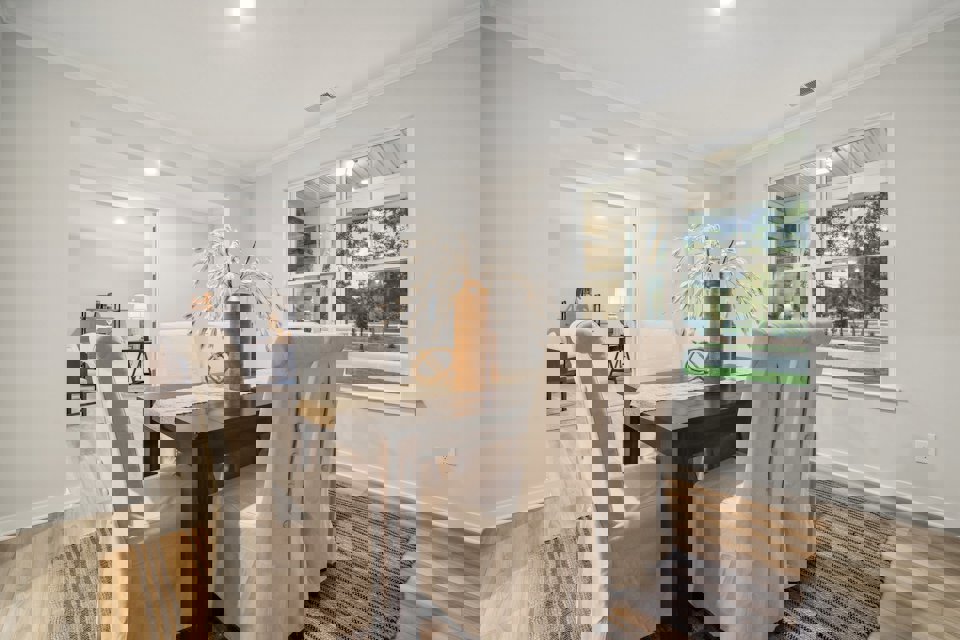 A dining room with a table and chairs.