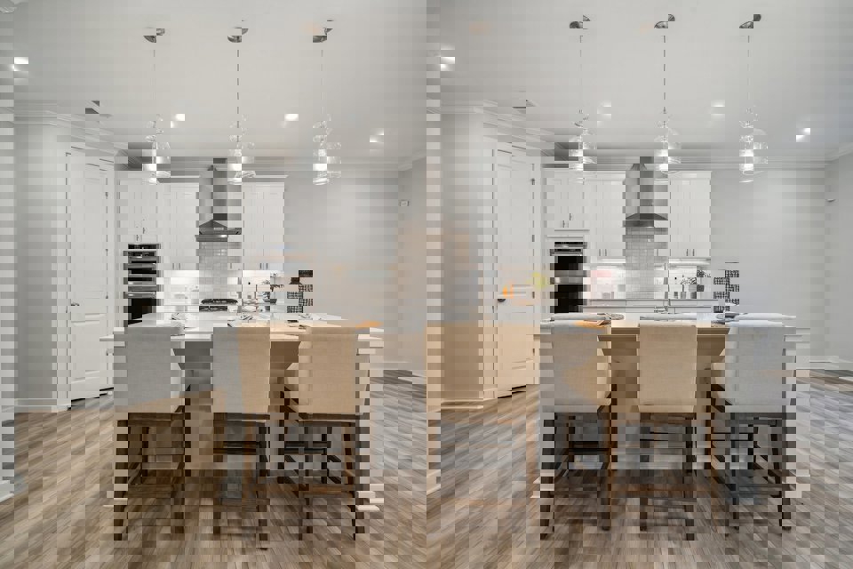 A kitchen with a table and chairs.