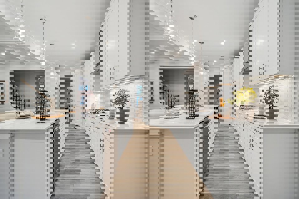 A kitchen with white cabinets.