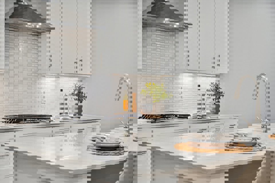 A kitchen with white cabinets.