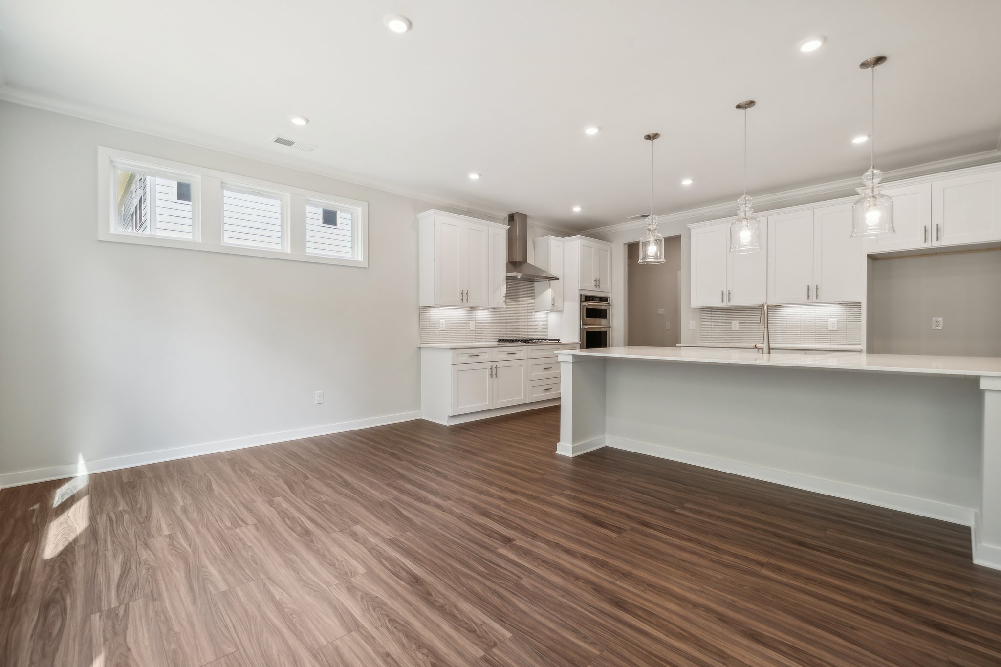 A large kitchen with white cabinets.