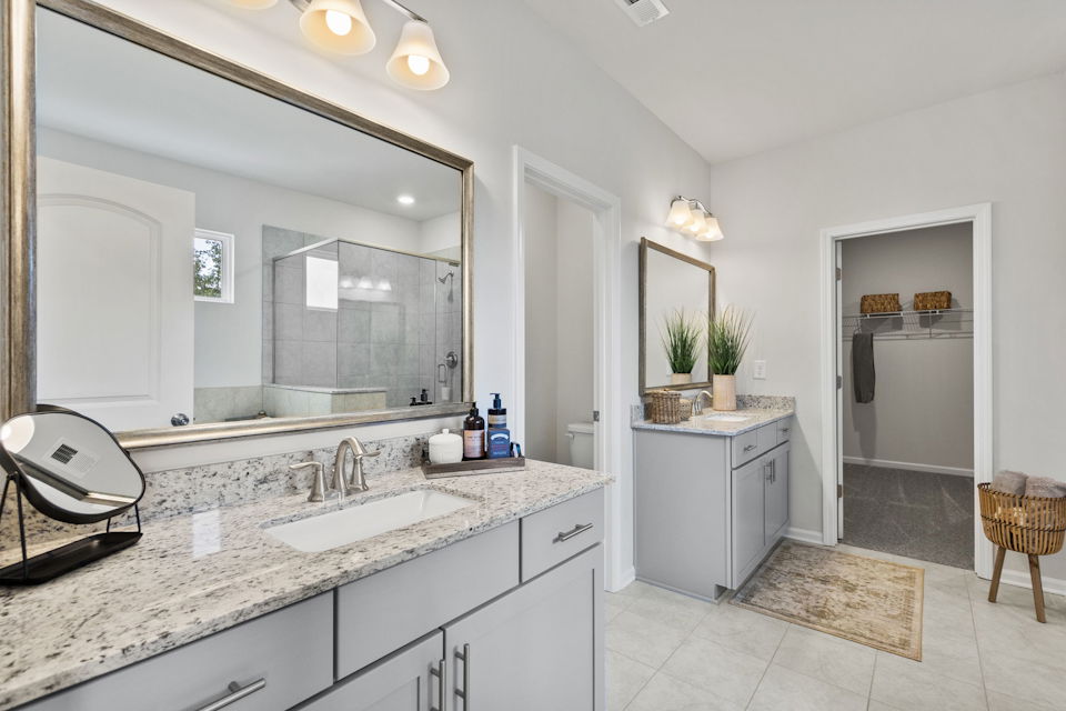A bathroom with a large mirror.