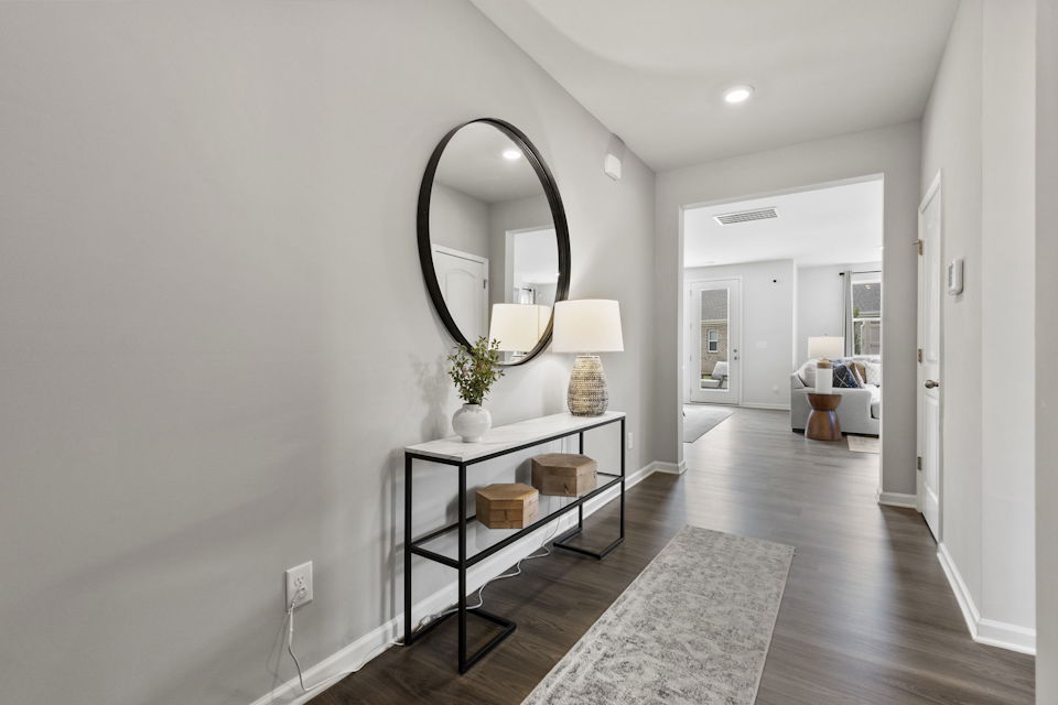 A room with a mirror and a table.