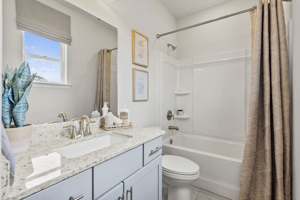 A bathroom with a shower and sink.