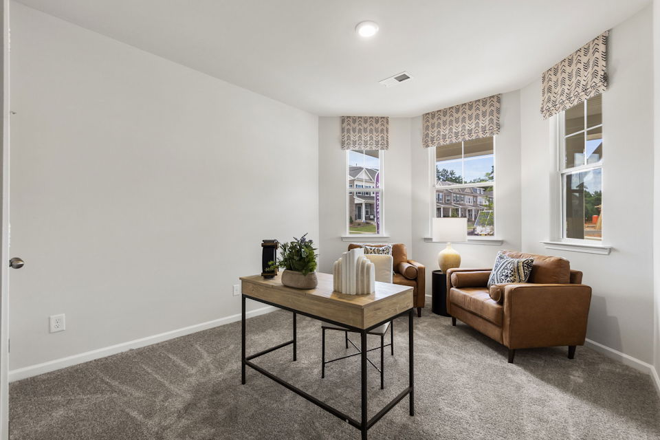 A living room with a table and chairs.