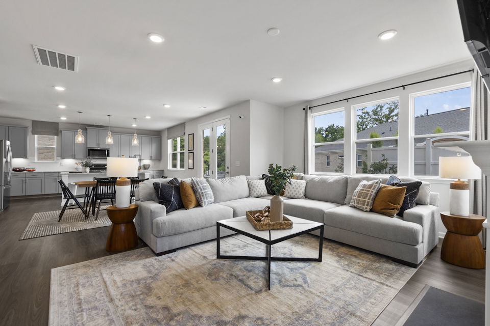 A living room with a large rug.