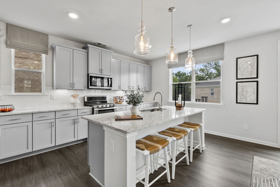 A kitchen with white cabinets.