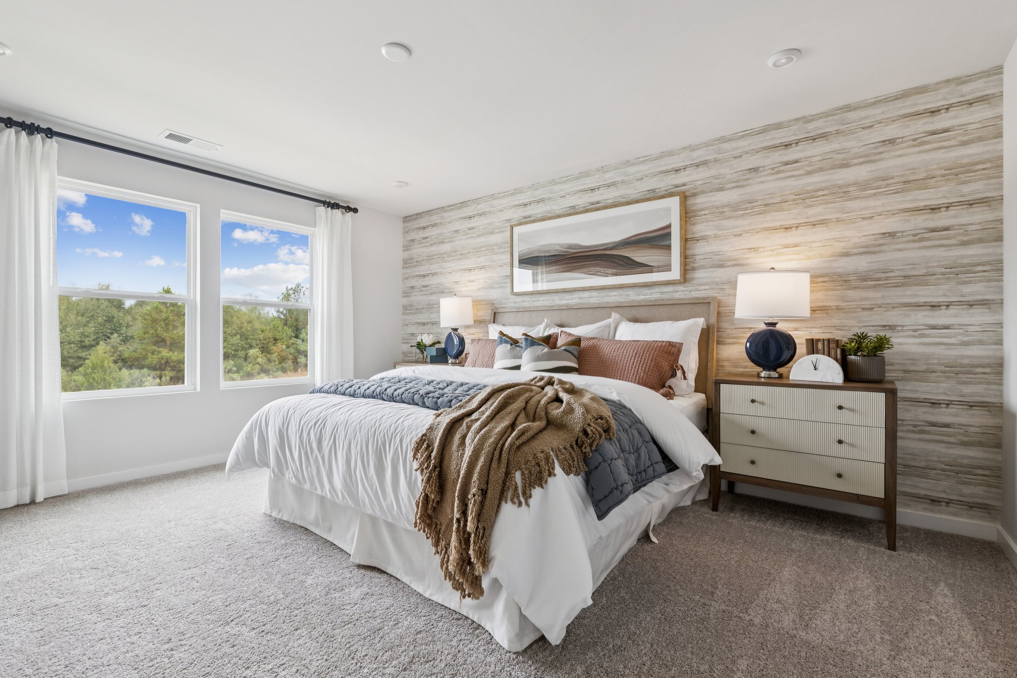 A bedroom with a bed and a window.