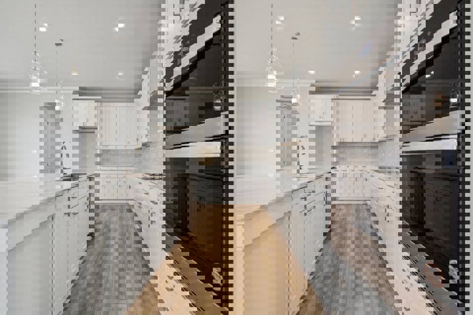 A kitchen with white cabinets.