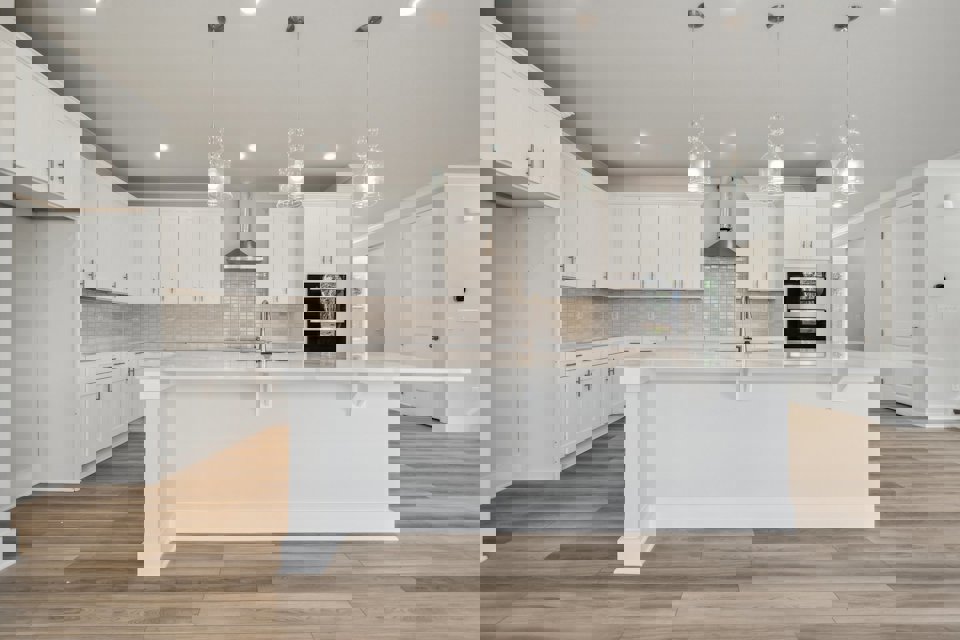 A kitchen with white cabinets.