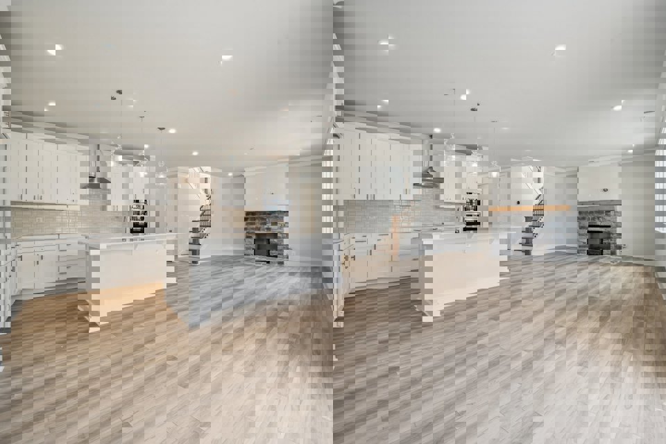 A large kitchen with white cabinets.