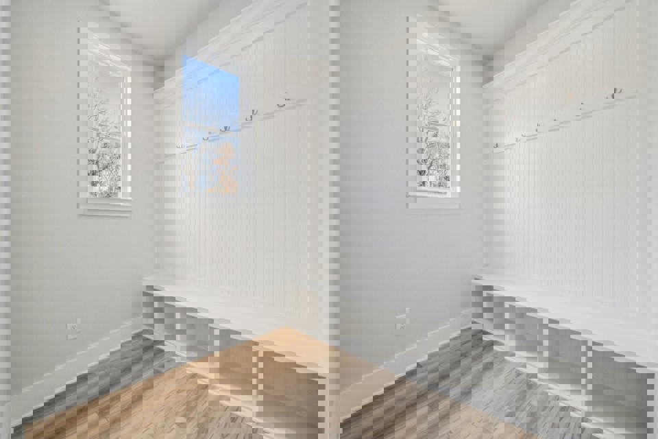 A room with white walls and a wood floor.