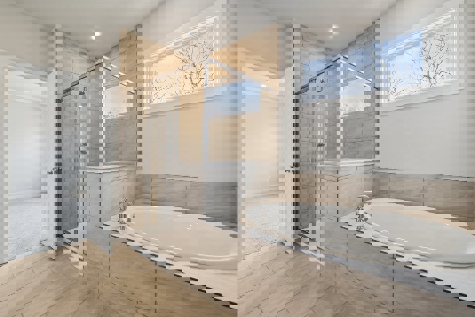 A bathroom with a tub and shower.