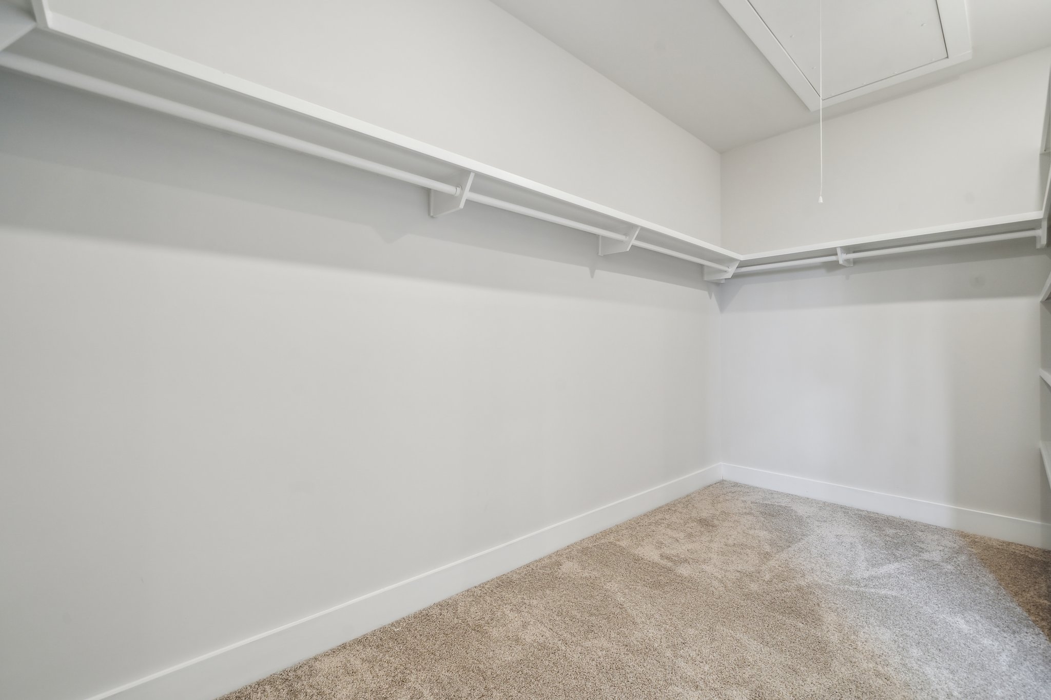 A white room with a carpet.