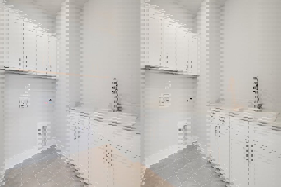 A white kitchen with white cabinets.