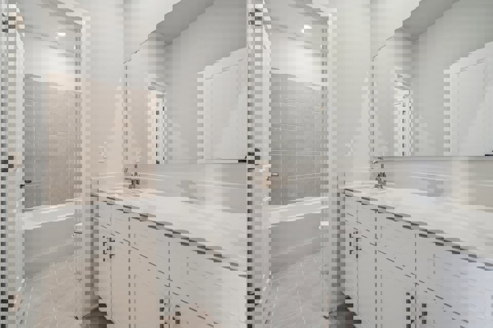 A bathroom with a tub sink and toilet.