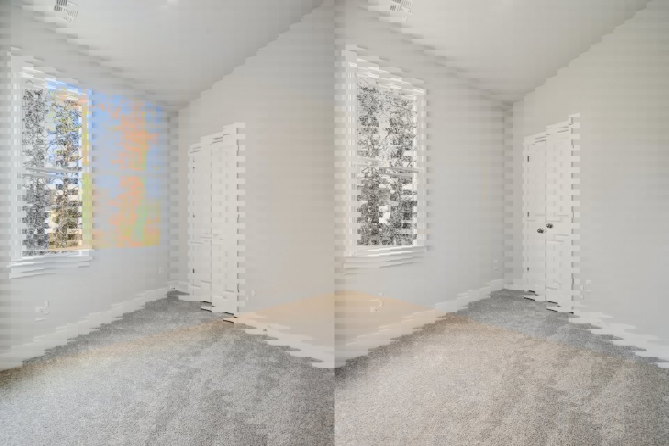 A room with a window and a door.