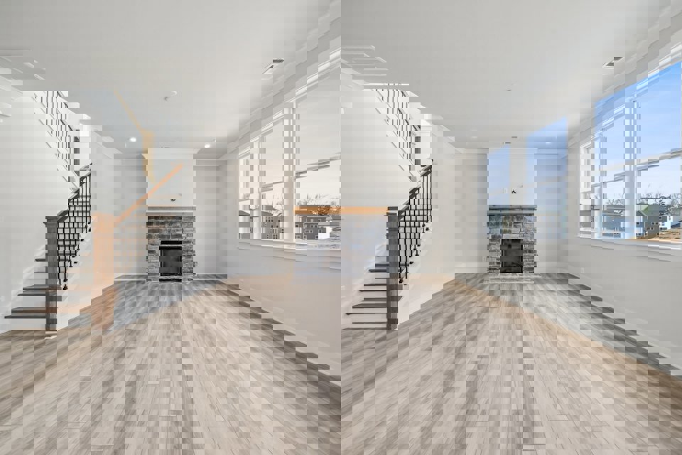 A large living room with a fireplace.