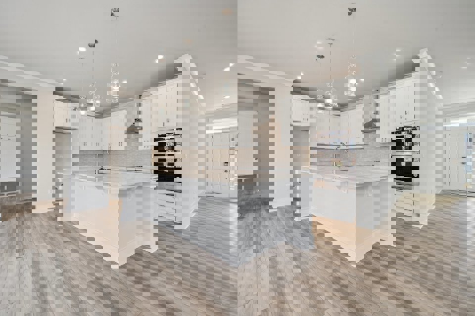 A kitchen with white cabinets.