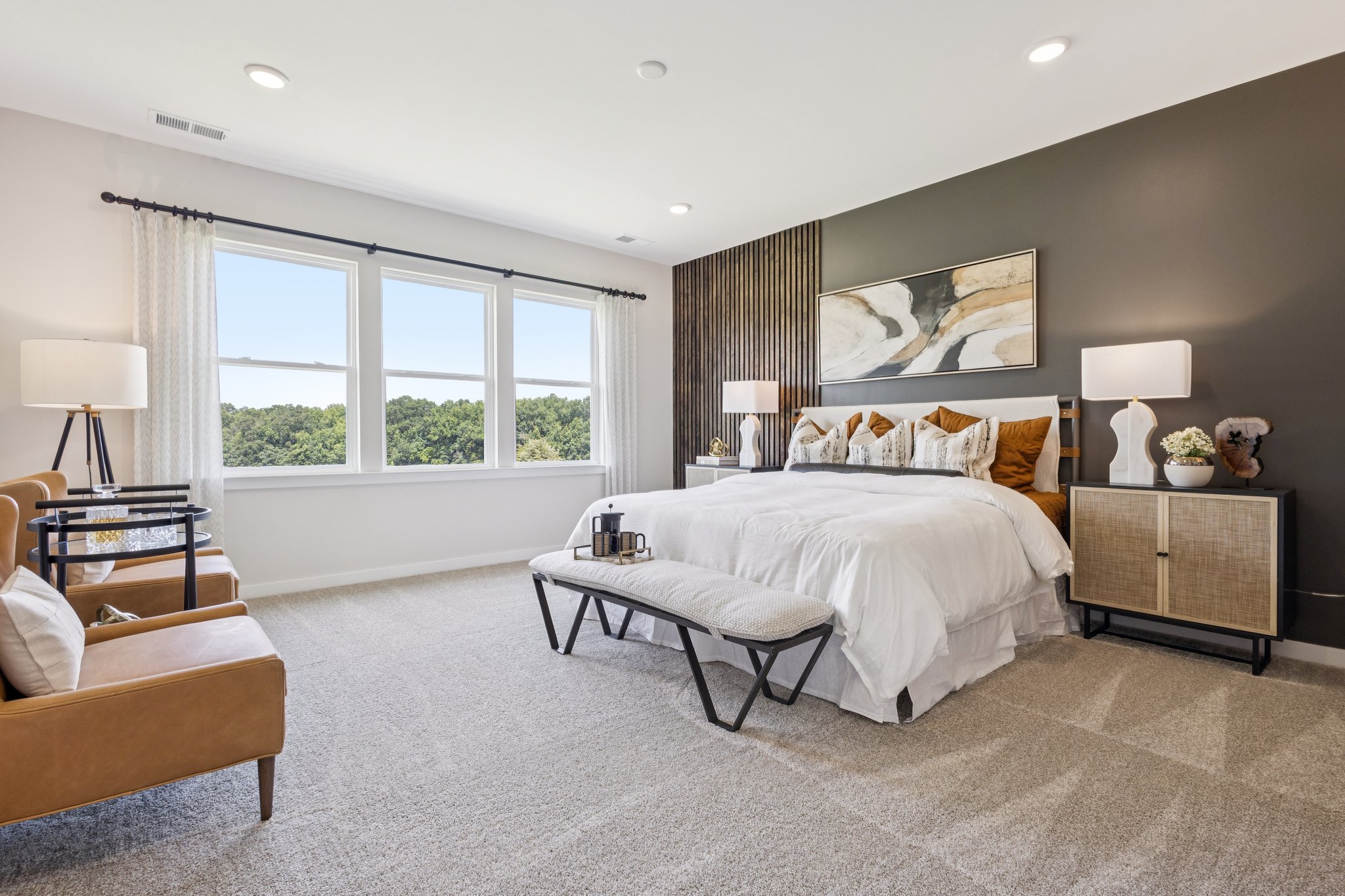 A bedroom with a bed and a table.