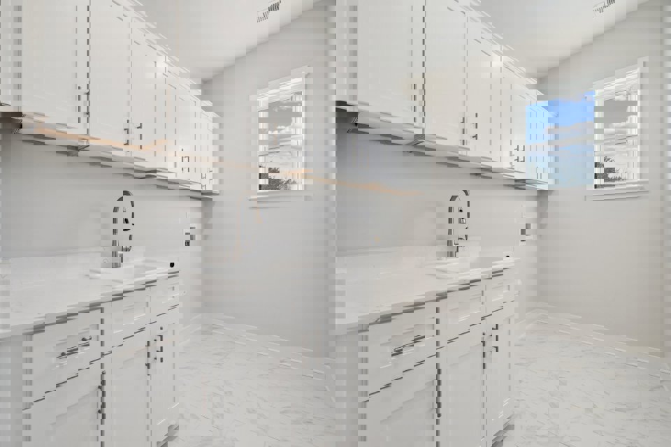 A white kitchen with white cabinets.