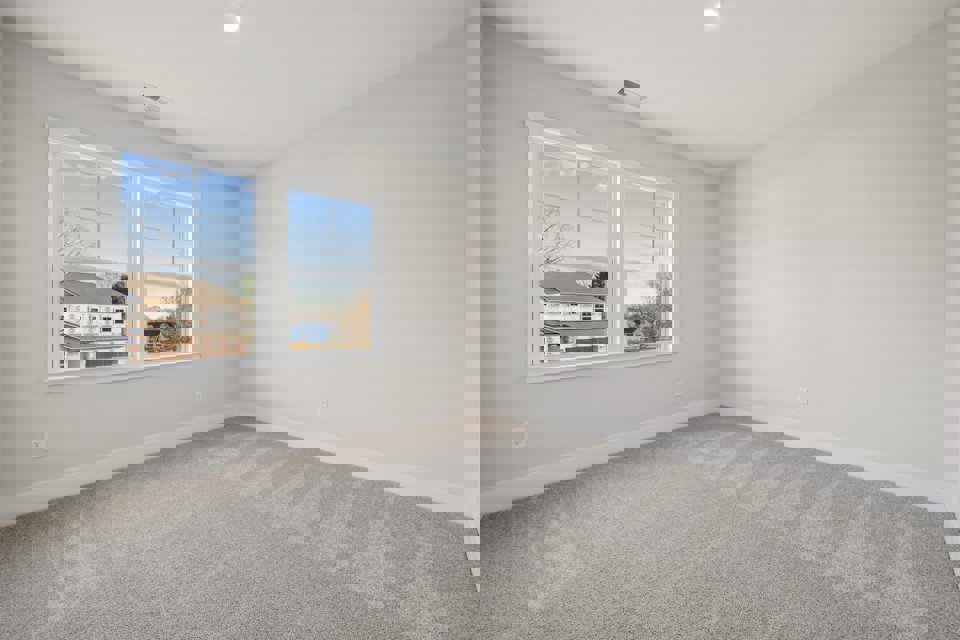 A room with a window and a carpet.