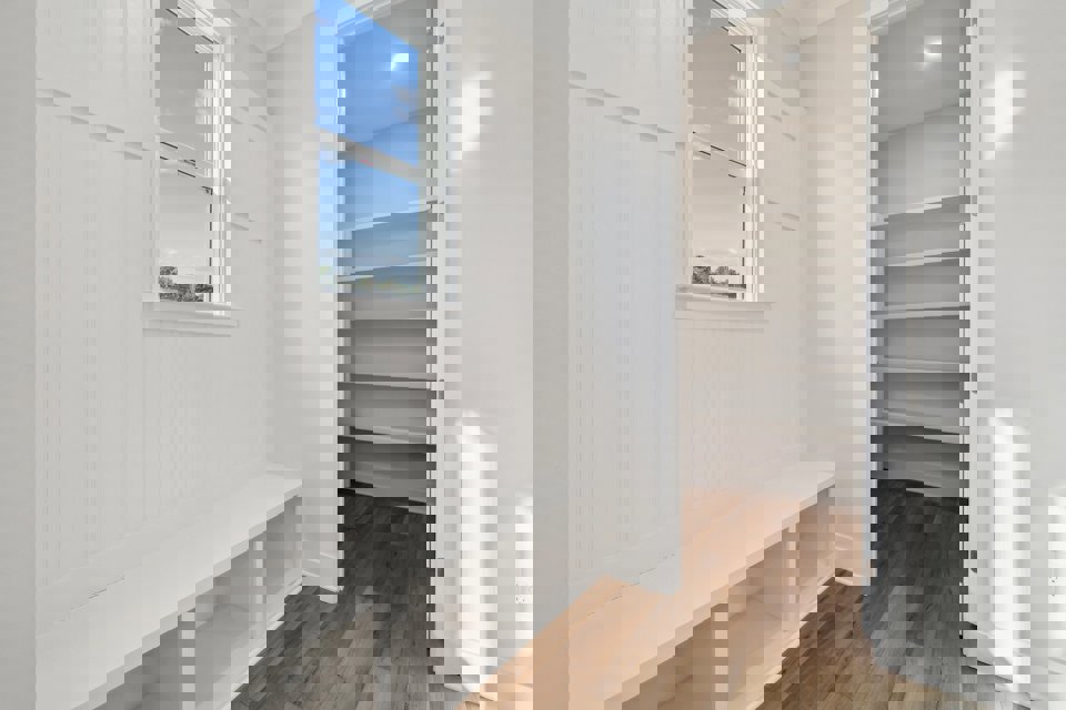 A room with white walls and a window.