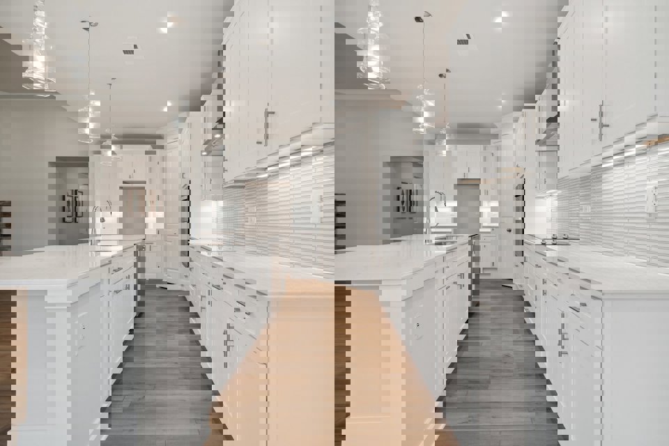 A kitchen with white cabinets.