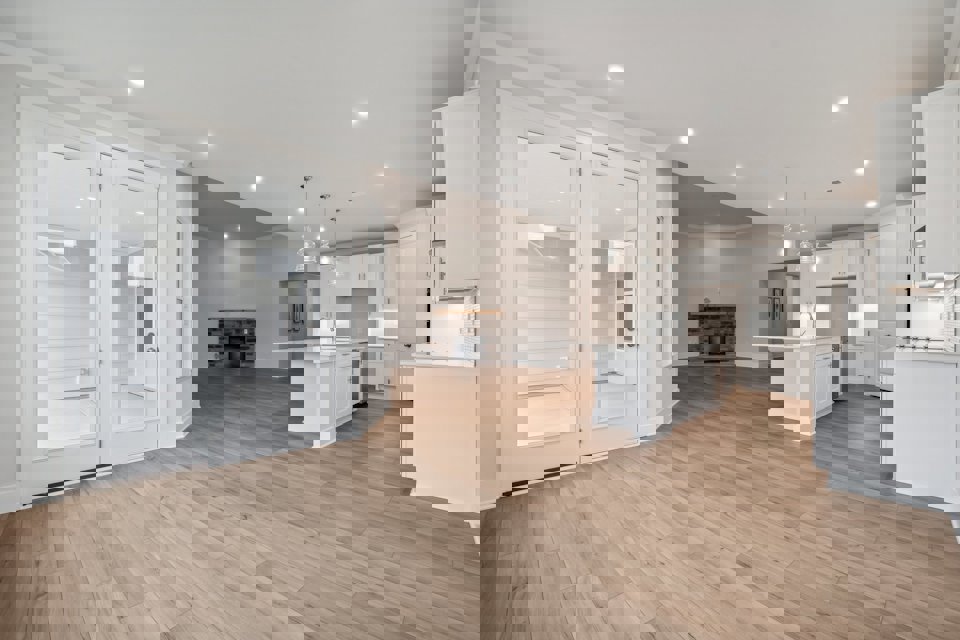 A large kitchen with white cabinets.