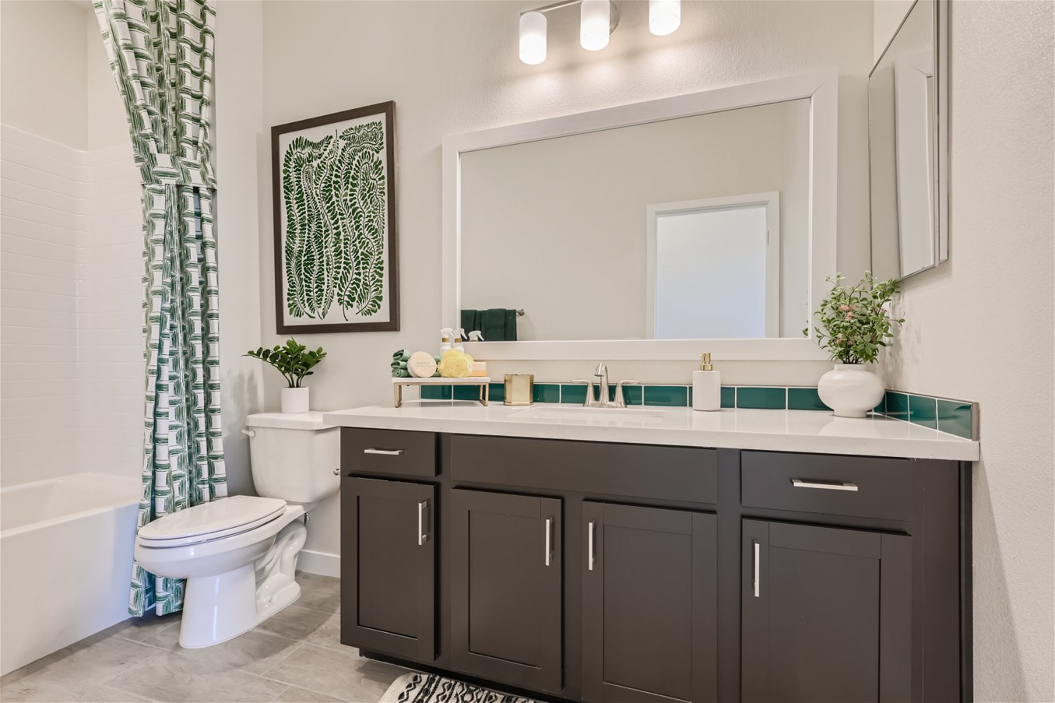 A bathroom with a tub sink and toilet.