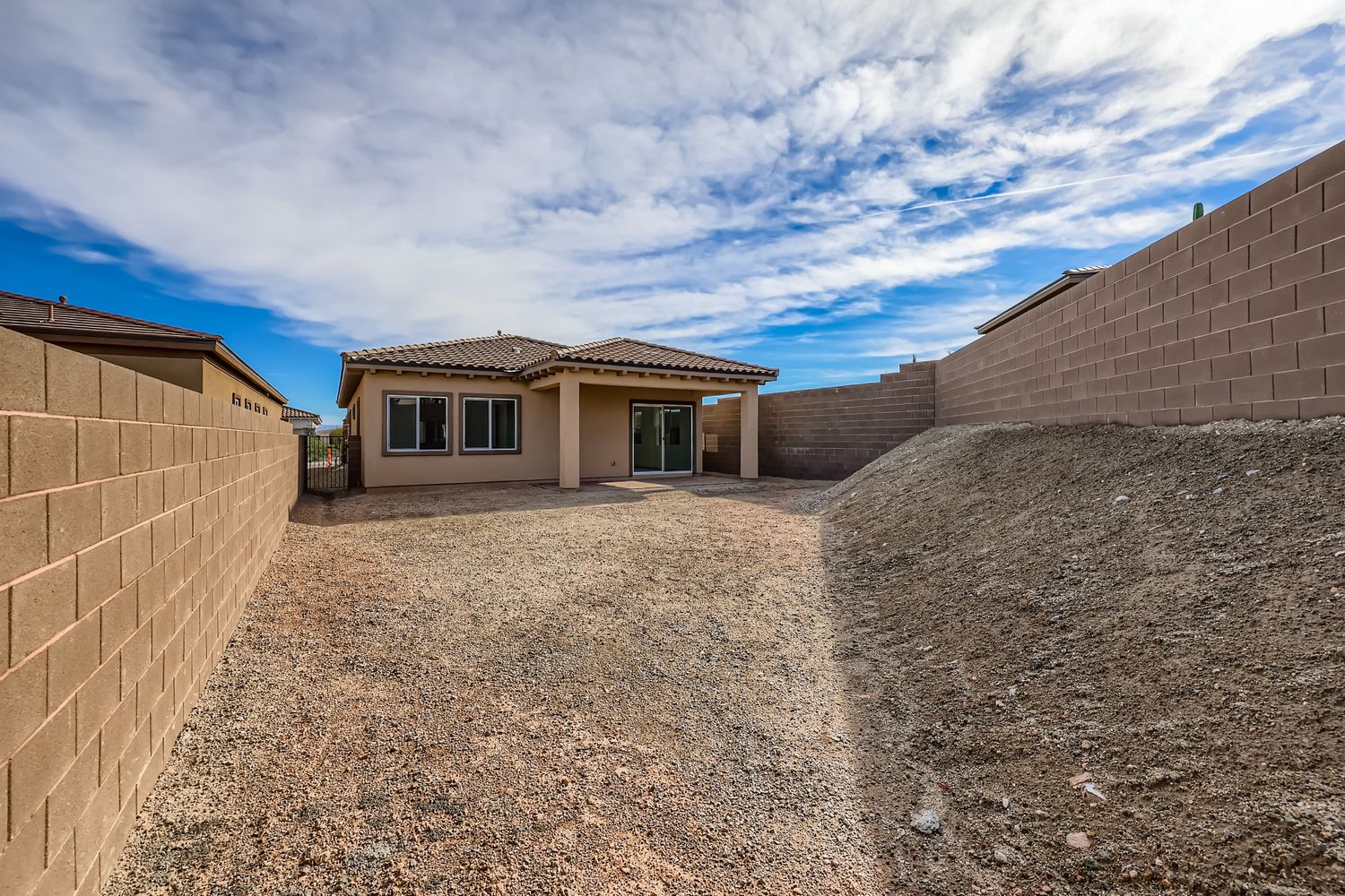 A house with a dirt yard.