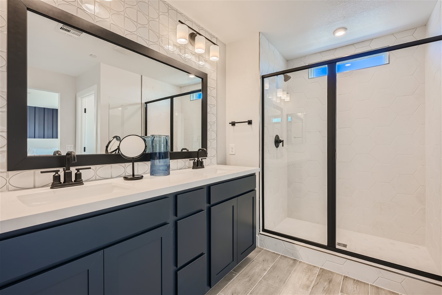 A bathroom with a large mirror.