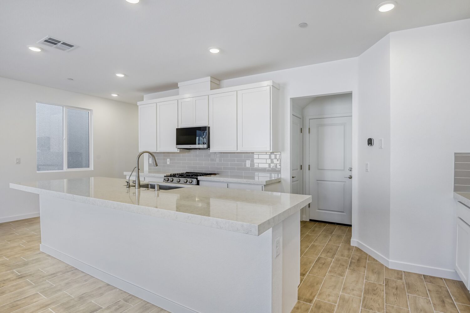 A kitchen with white cabinets.