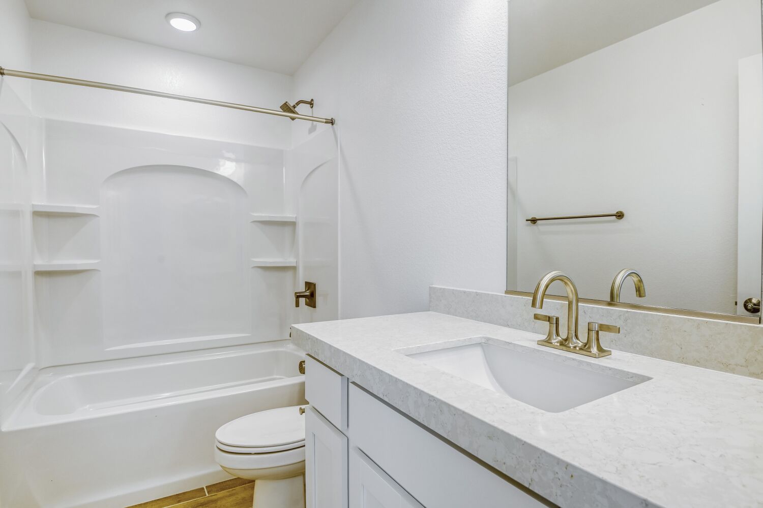 A bathroom with a sink toilet and bathtub.