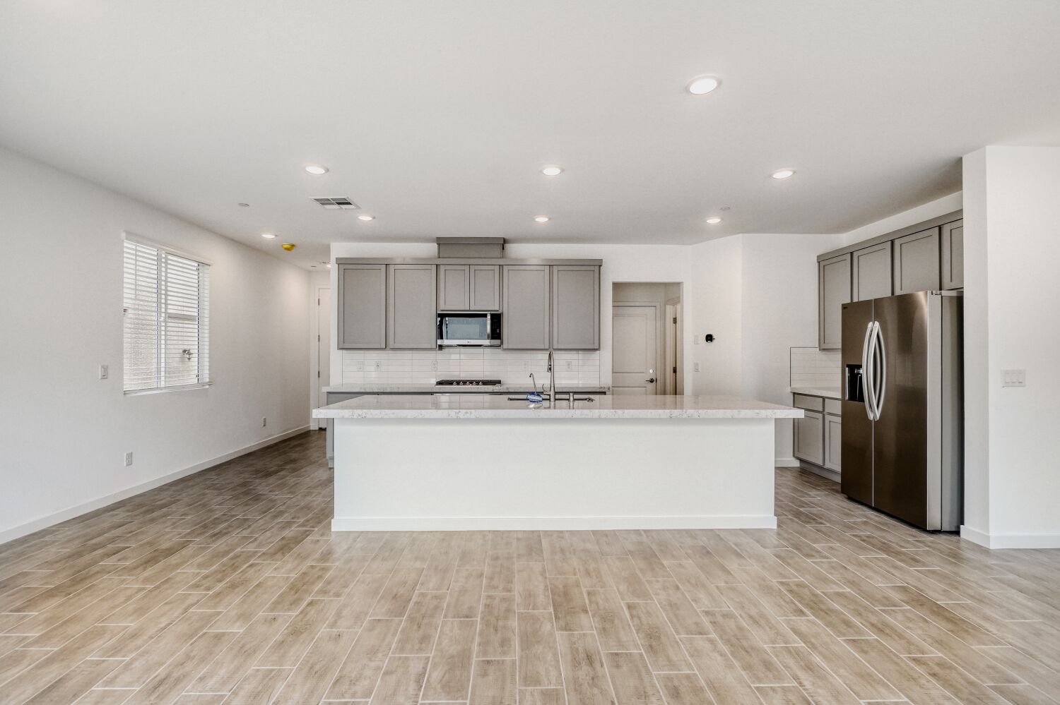 A kitchen with white cabinets.