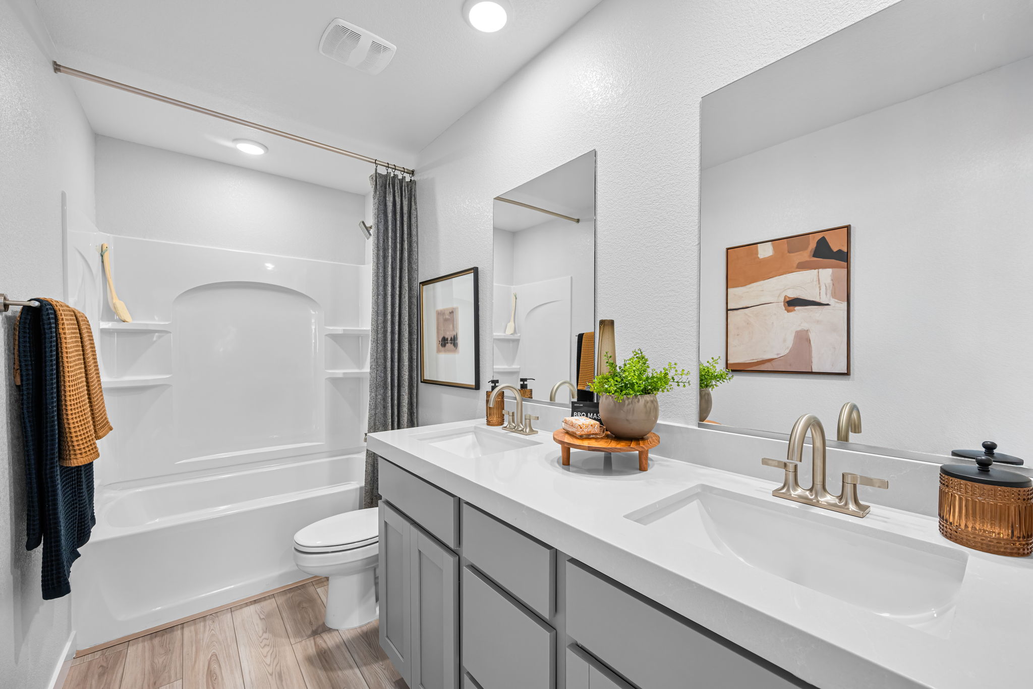 A bathroom with a tub sink and toilet.