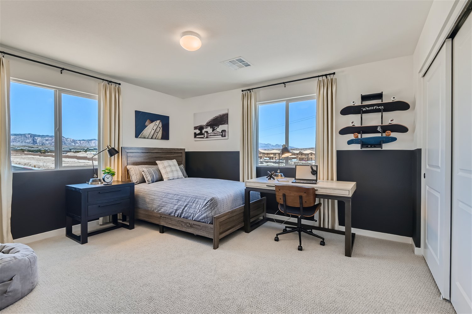 A bedroom with a desk and a chair.