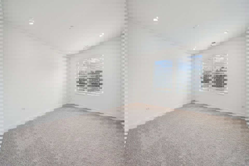 A room with a window and a carpet.