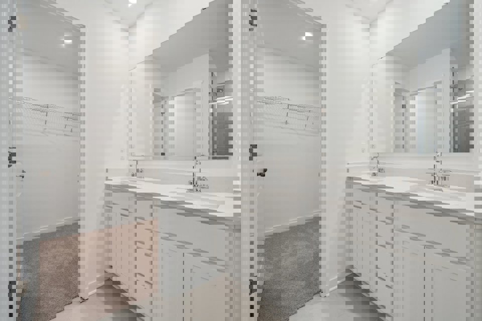 A bathroom with a sink and a shower unit.