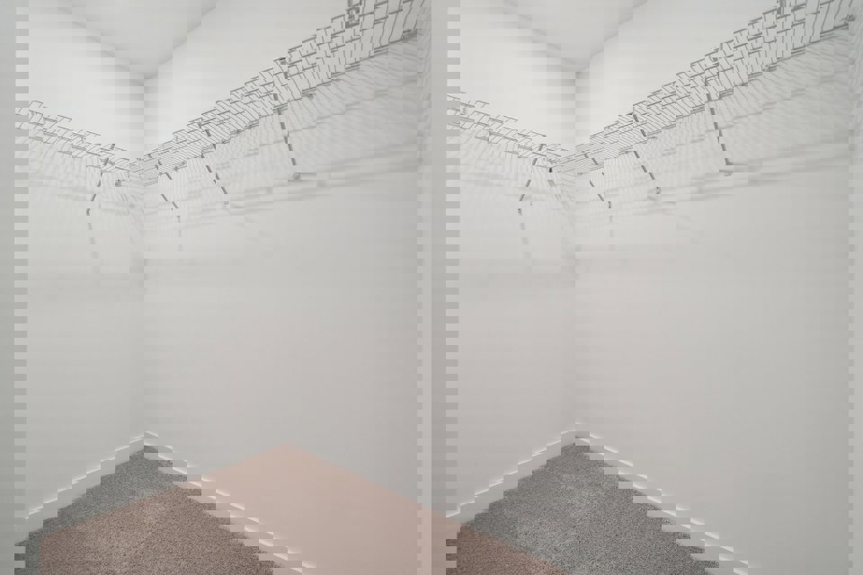 A white wall with a white floor.