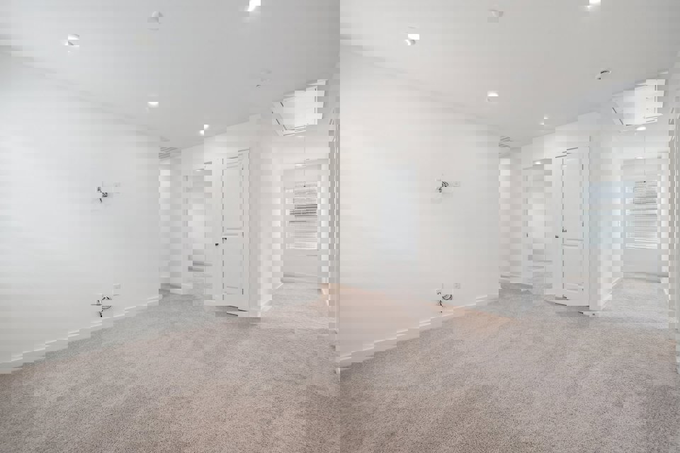 A room with white walls and a carpeted floor.