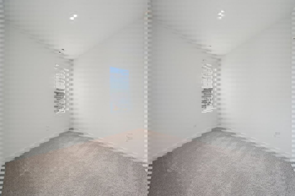 A room with a window and carpet.