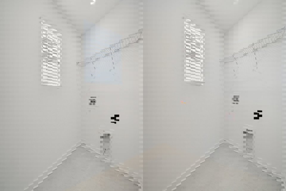 A white room with a window.