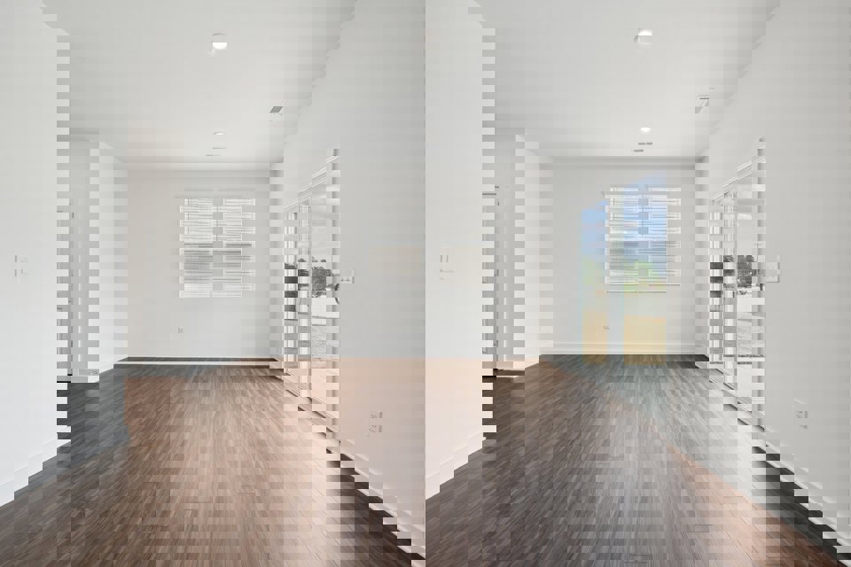 A room with a wood floor and white walls.