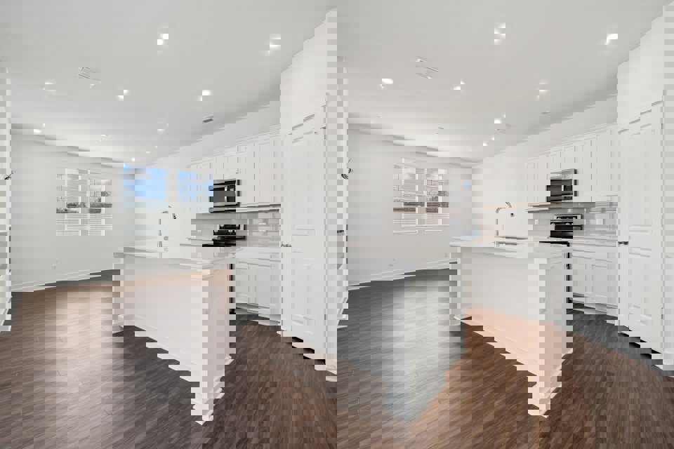 A kitchen with white cabinets.