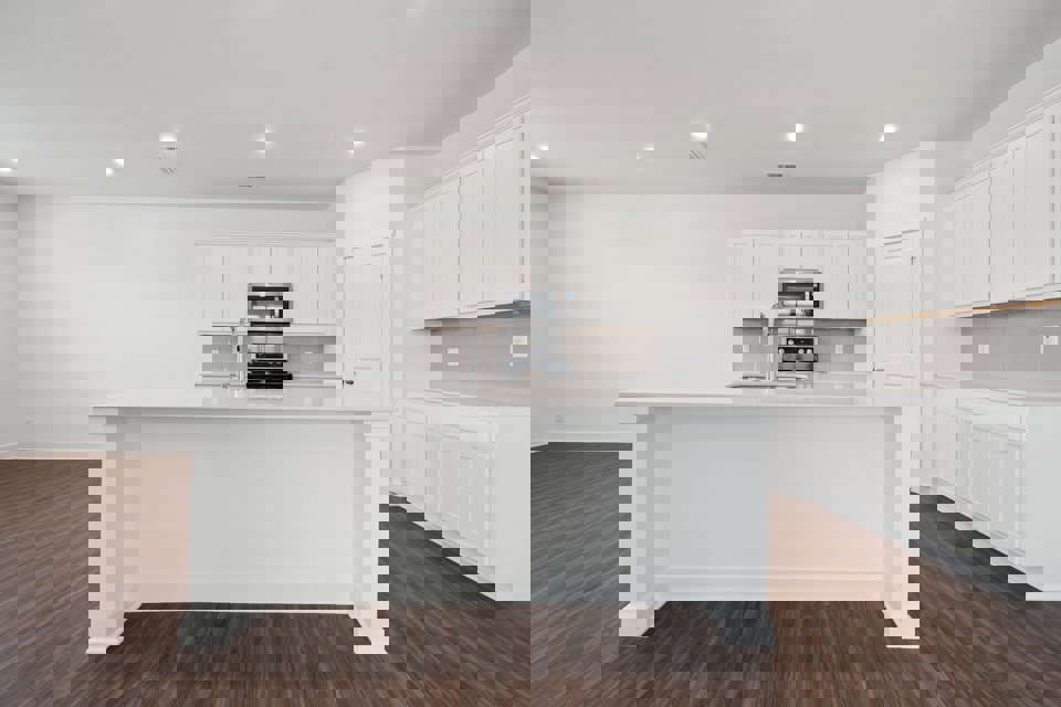 A kitchen with white cabinets.