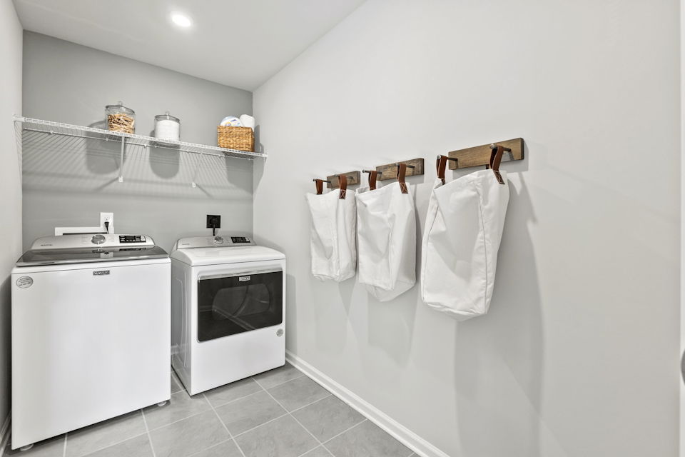 A kitchen with white towels on a rack.