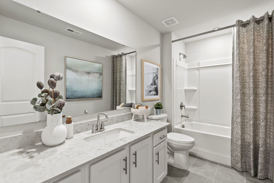 A bathroom with a tub sink and toilet.