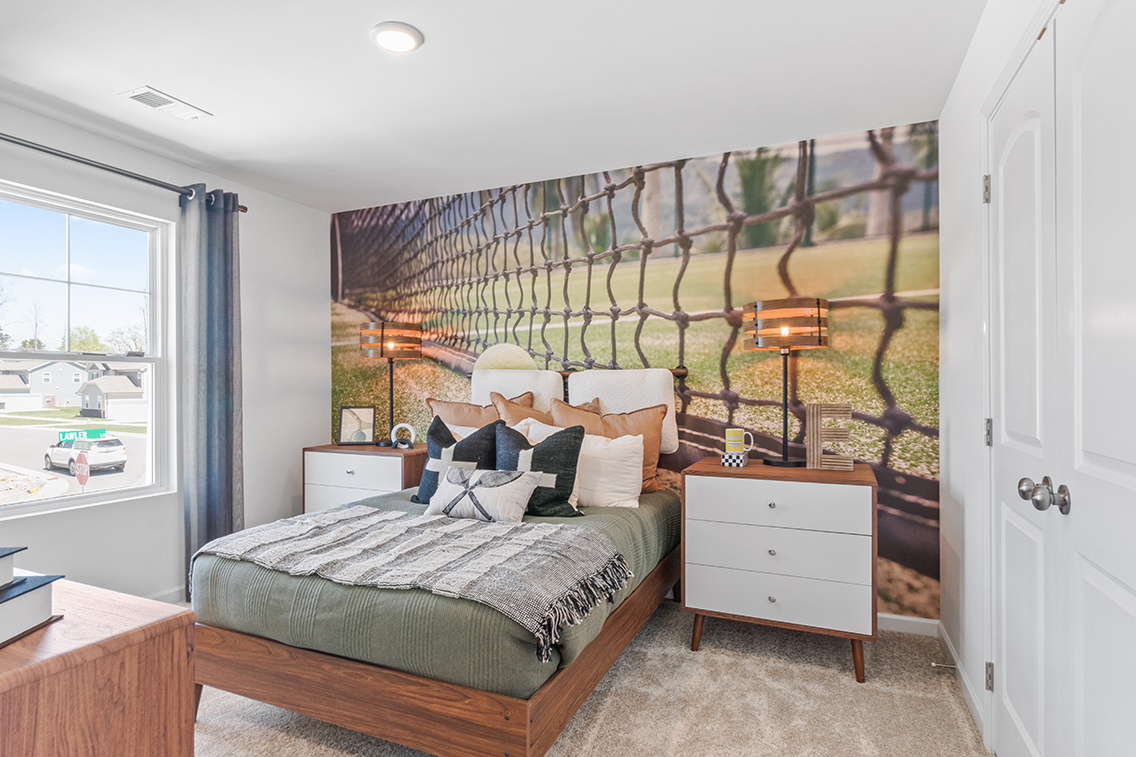 A bedroom with a bed and a window.